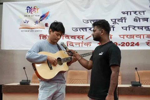 NEC employee participating in the Hindi music competition or