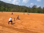 A batsman poing to hit a ball during a cricket match