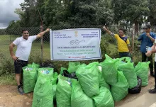 NEC officials with bags of trash collected during the Transf