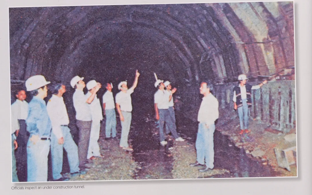 Officials inspect an under construction tunnel